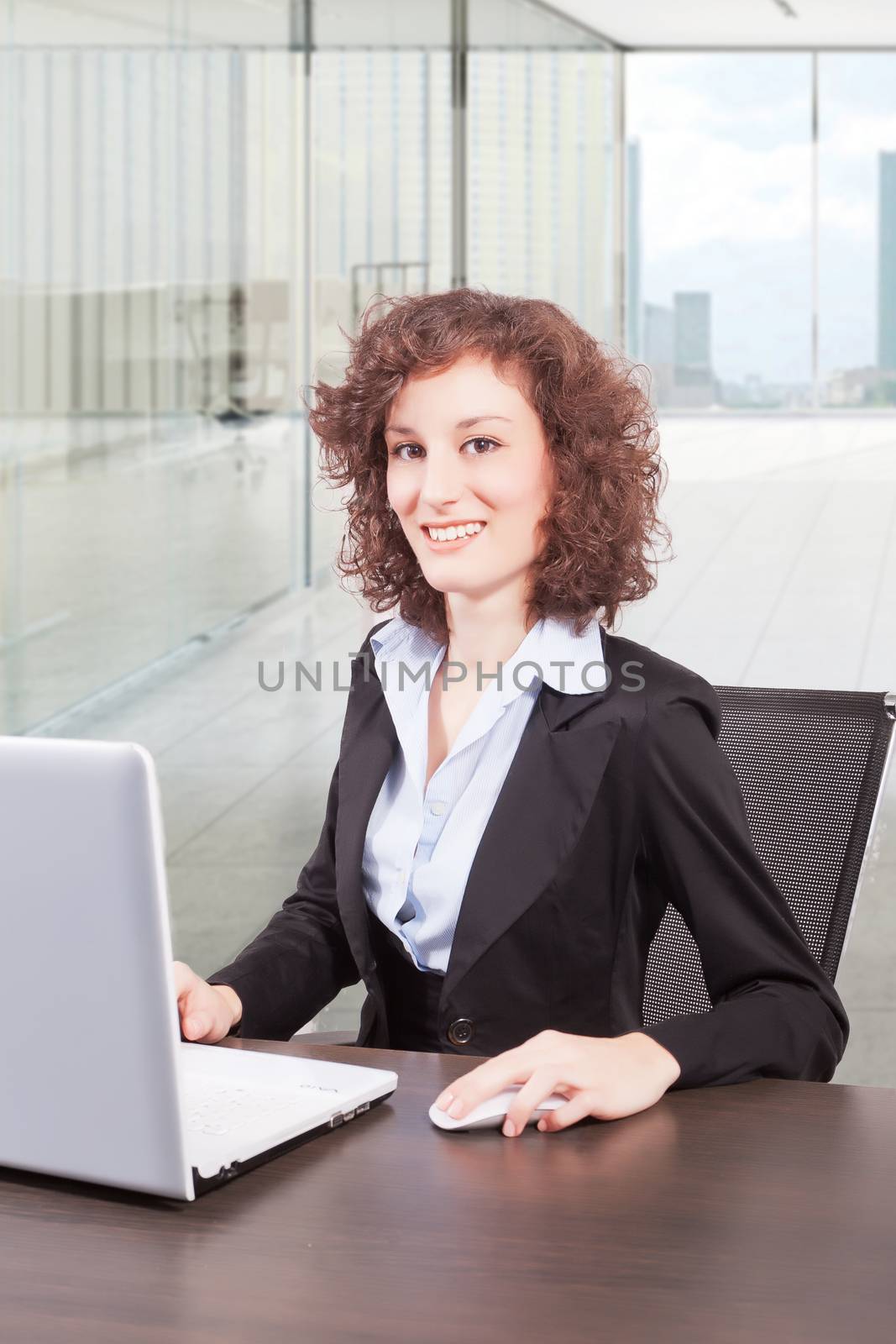 businesswoman in office by matteobragaglio