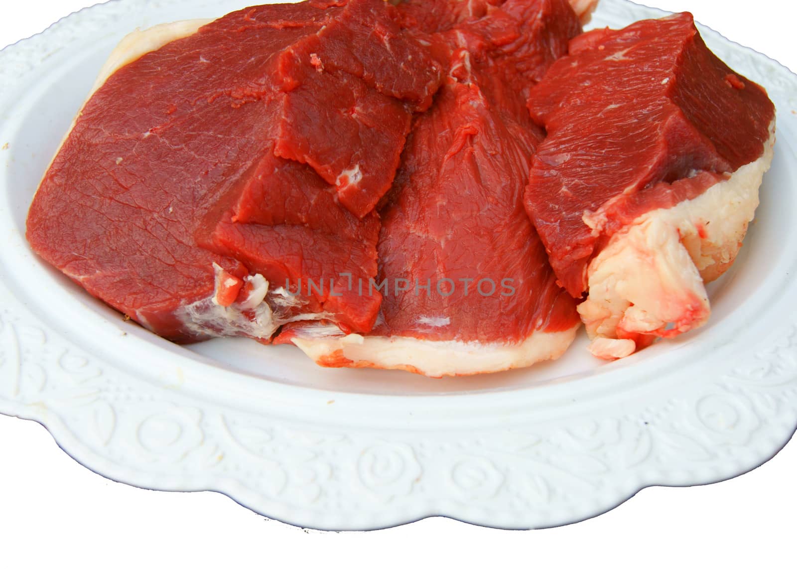 Damp meat on plate on white background