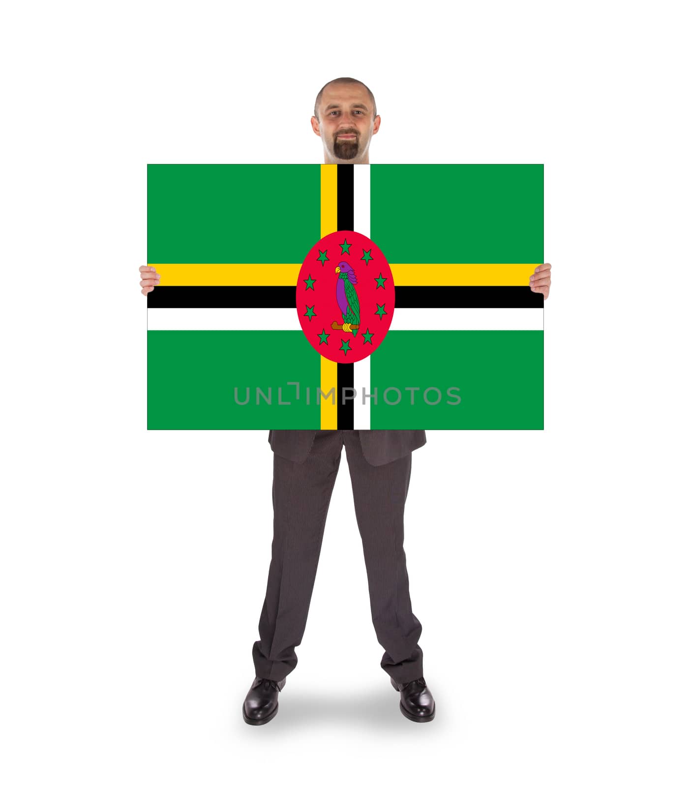 Smiling businessman holding a big card, flag of Dominica
