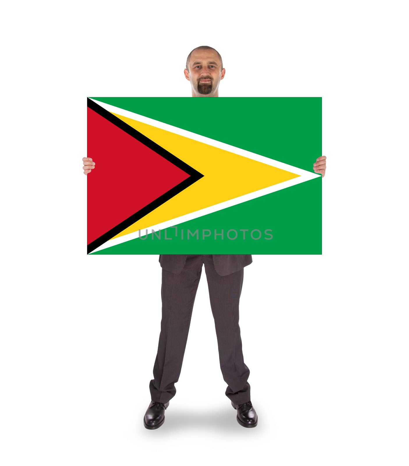 Smiling businessman holding a big card, flag of Guyana