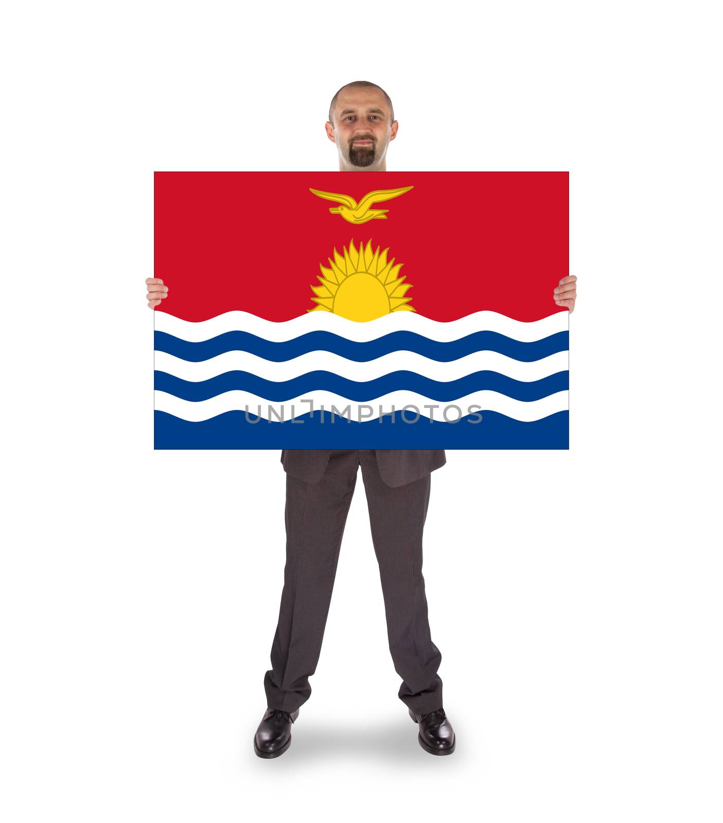 Smiling businessman holding a big card, flag of Kiribati