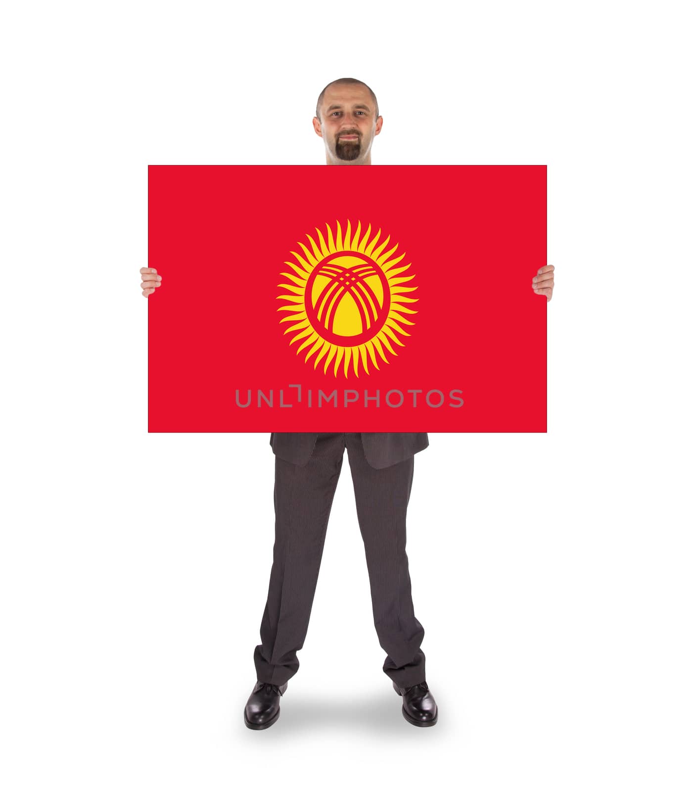 Smiling businessman holding a big card, flag of Kyrgyzstan