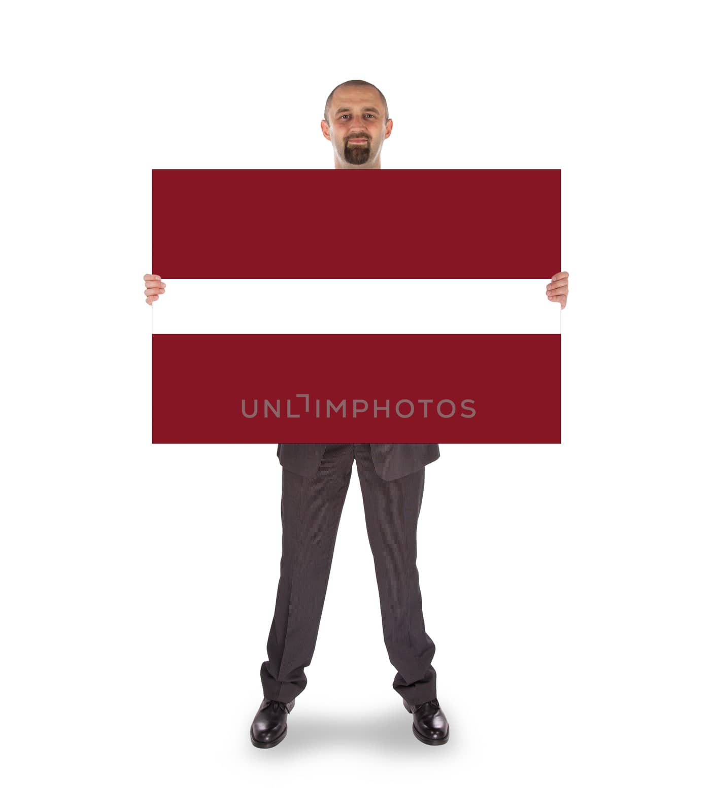 Smiling businessman holding a big card or flag by michaklootwijk