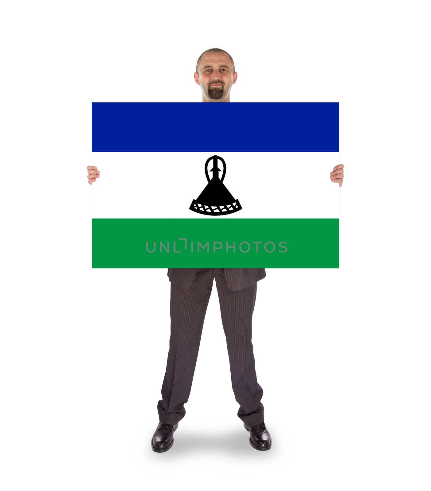 Smiling businessman holding a big card, flag of Lesotho