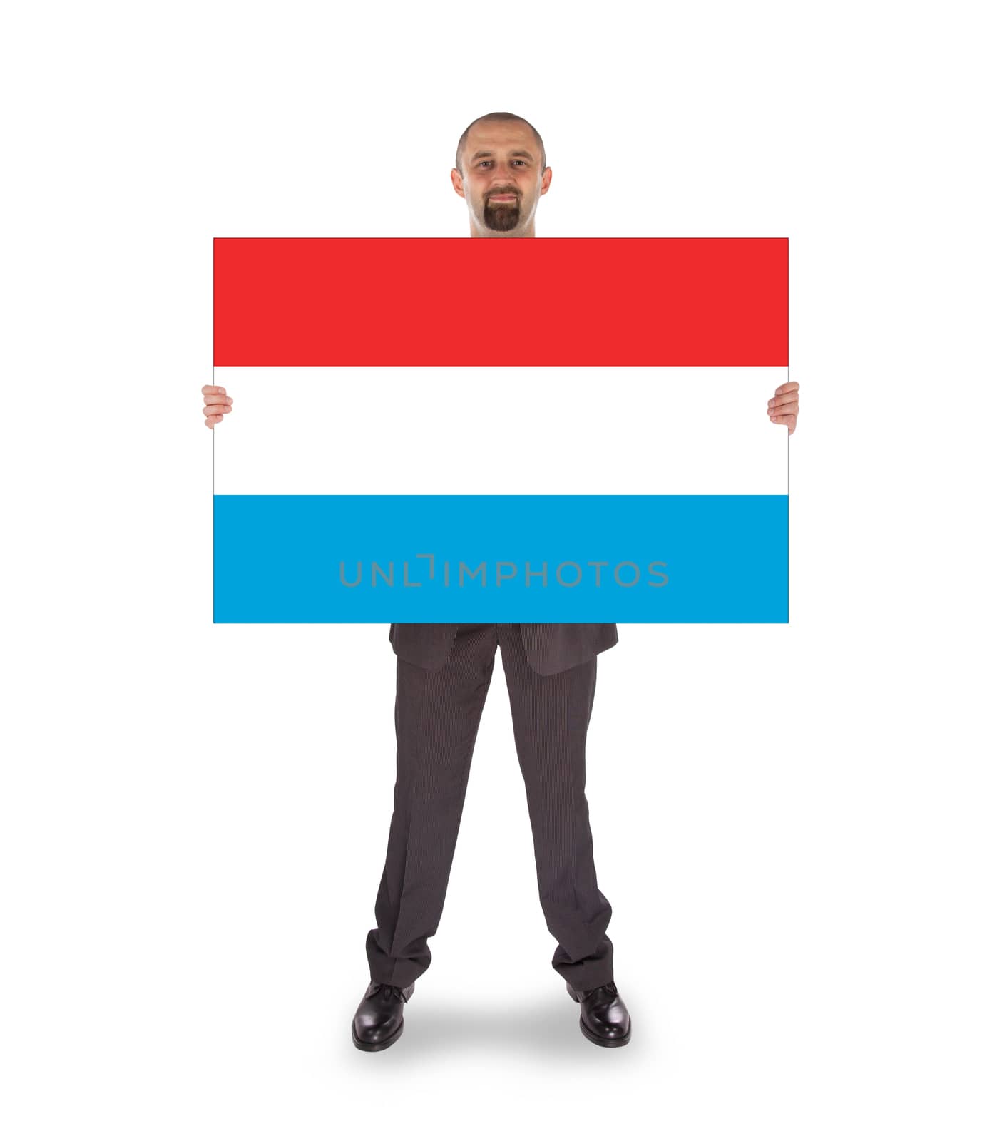 Smiling businessman holding a big card, flag of Luxembourg