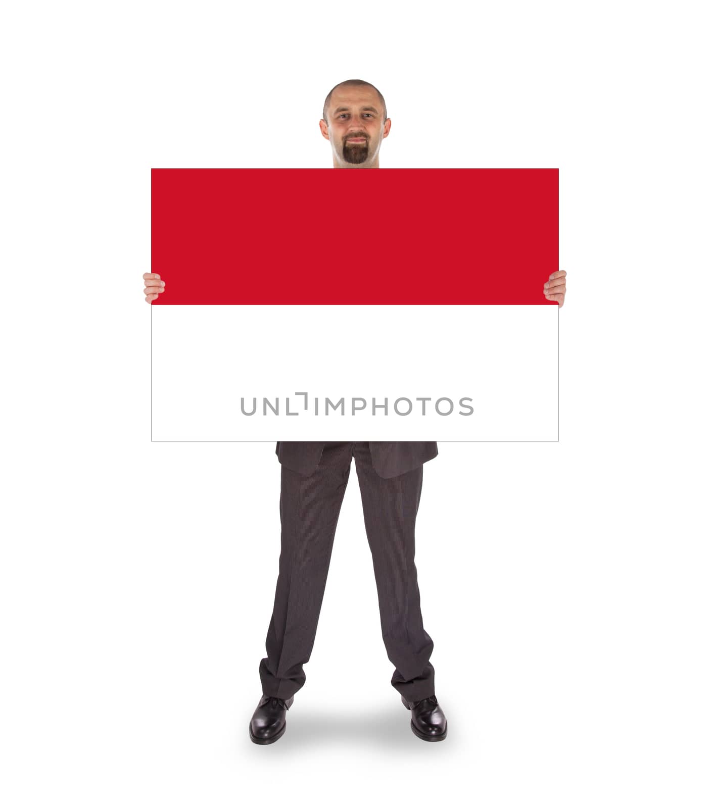 Smiling businessman holding a big card or flag by michaklootwijk