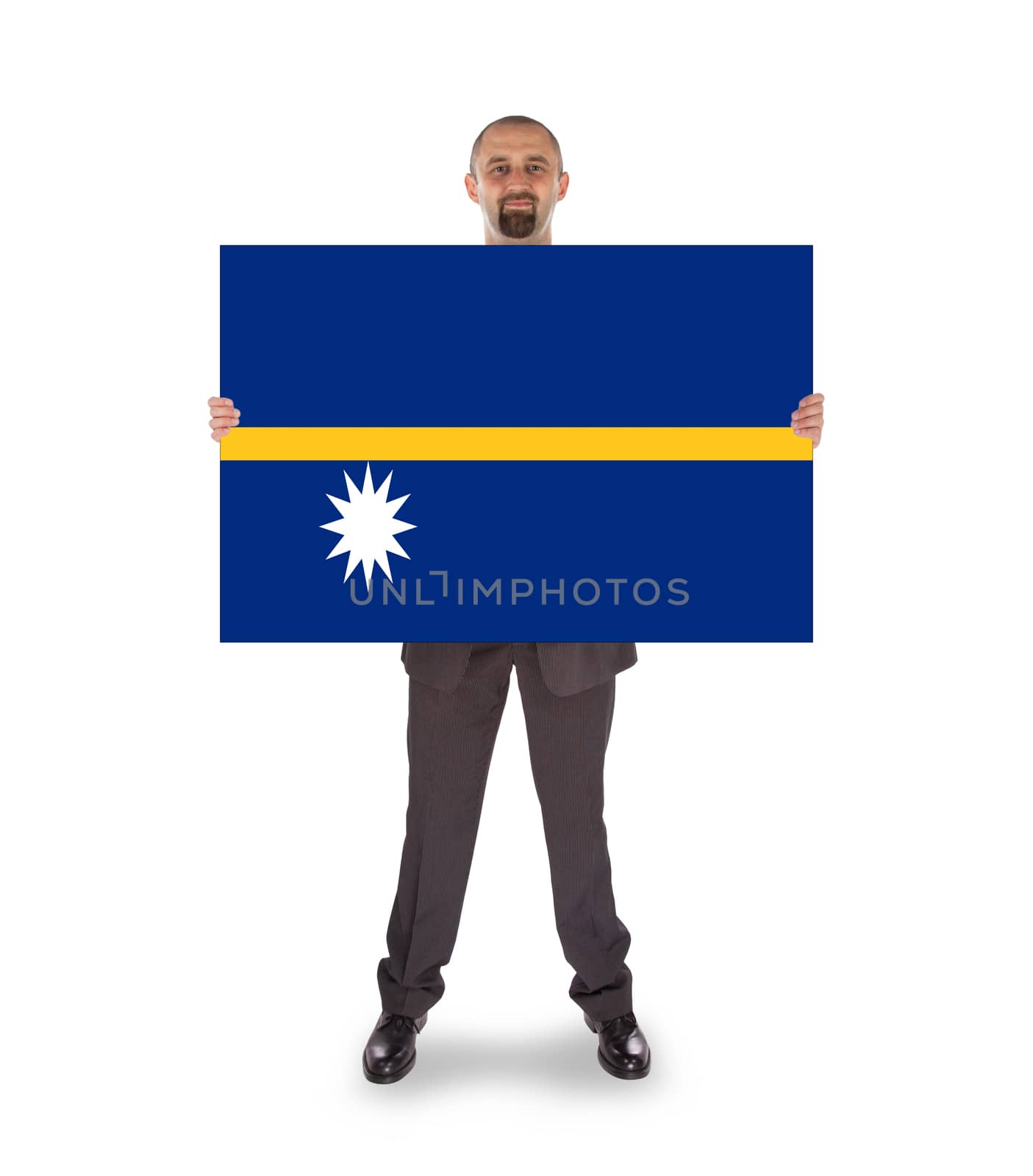 Smiling businessman holding a big card or flag by michaklootwijk