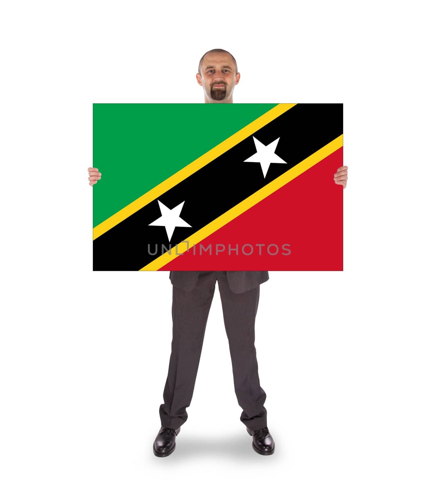 Smiling businessman holding a big card, flag of Saint Kitts and Nevis
