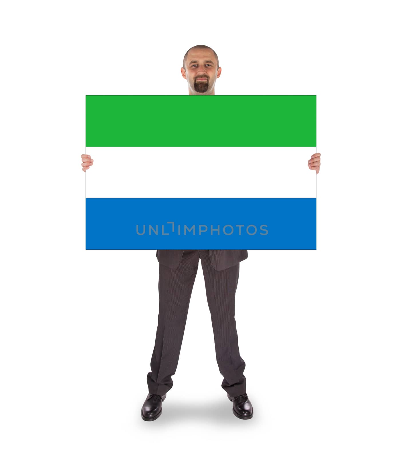 Smiling businessman holding a big card, flag of Sierra Leone