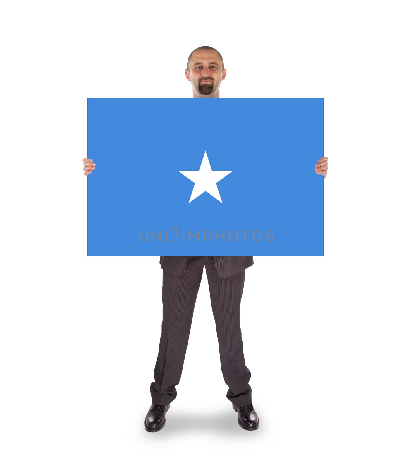 Smiling businessman holding a big card, flag of Somalia