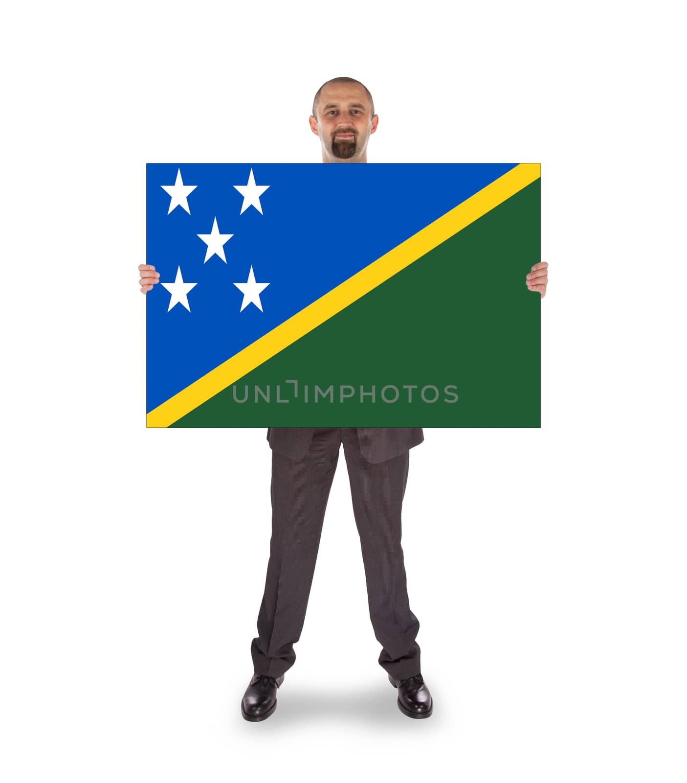 Smiling businessman holding a big card, flag of The Solomon Islands