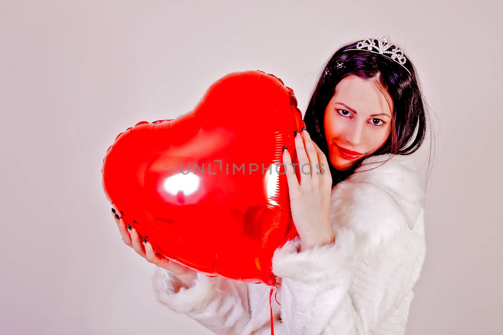 portrait of attractive girl holding shape of heart