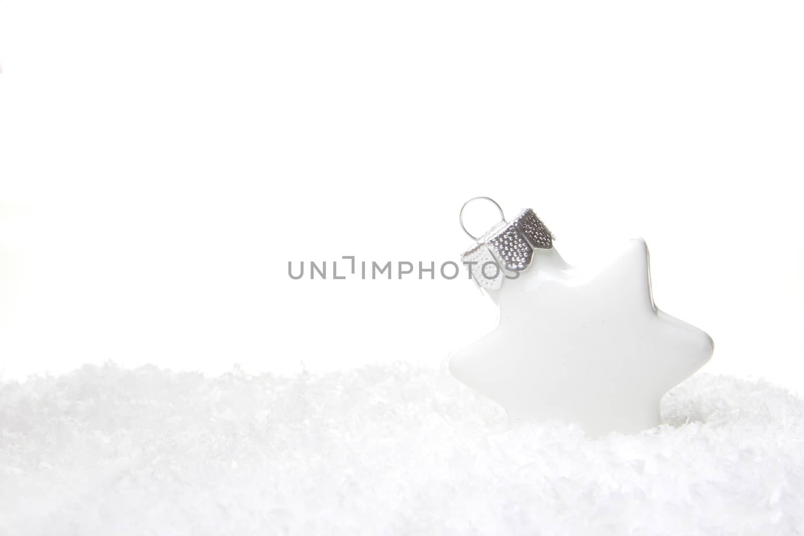 white christmas bauble as christmas star on snow 