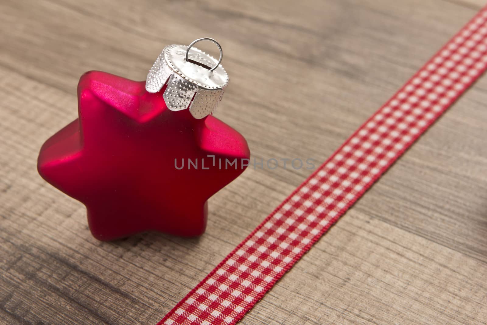 Christmas decoration with wood background, Christmas balls as star red with ribbon 