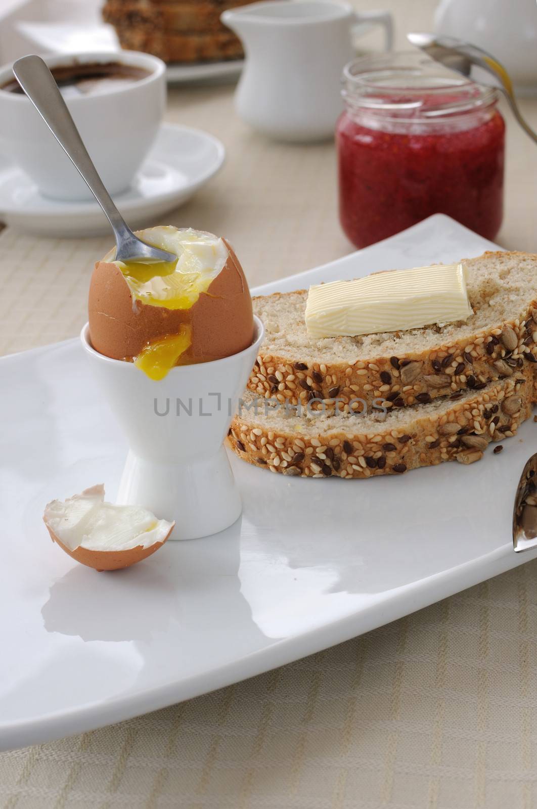 Breakfast with soft-boiled egg and slices of oatmeal bread by Apolonia