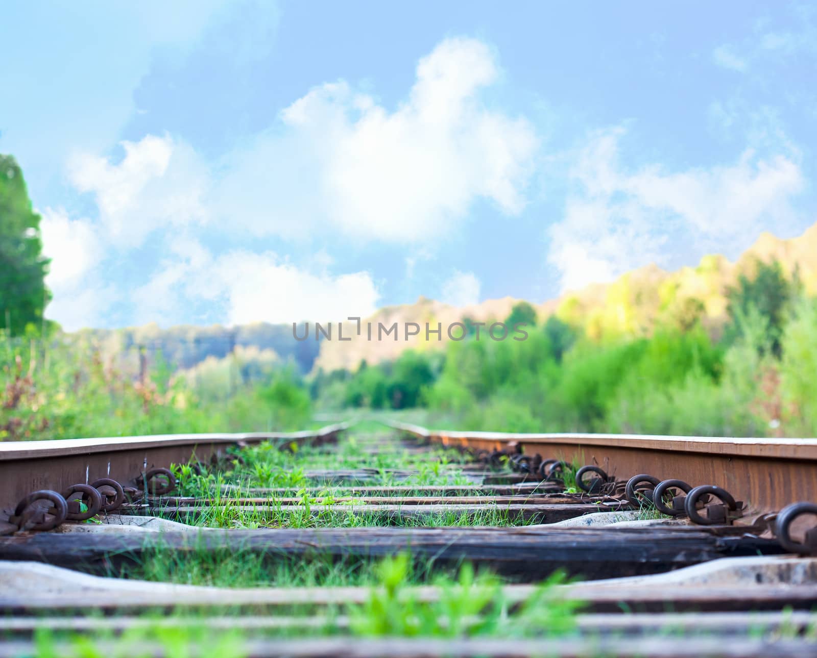 railroad to horizon under deep blue sky in sunset by sfinks