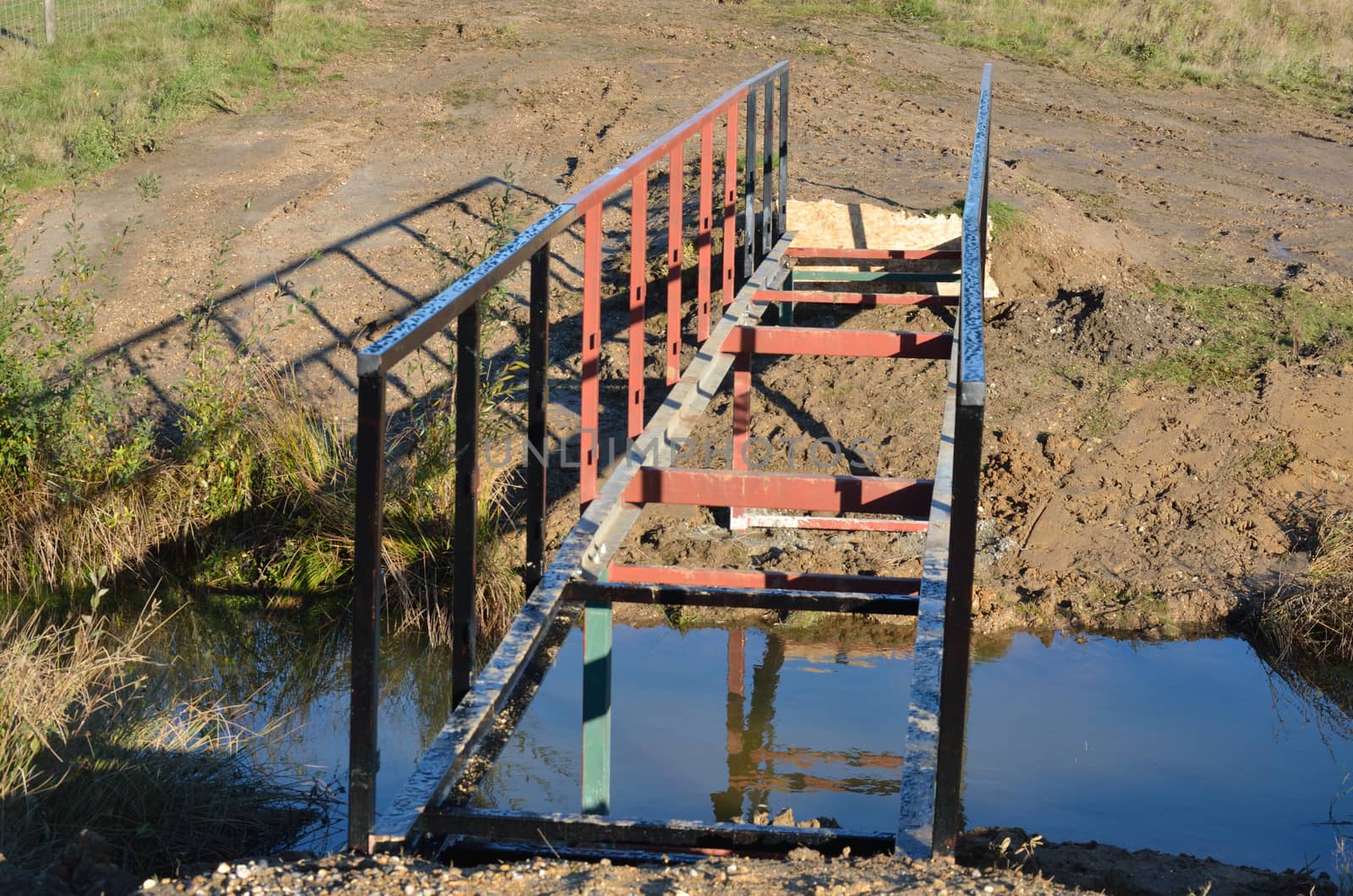 small incompete footbridge over stream