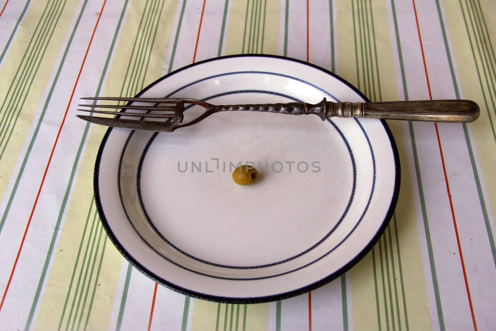 big old fork with knife on dish with olive