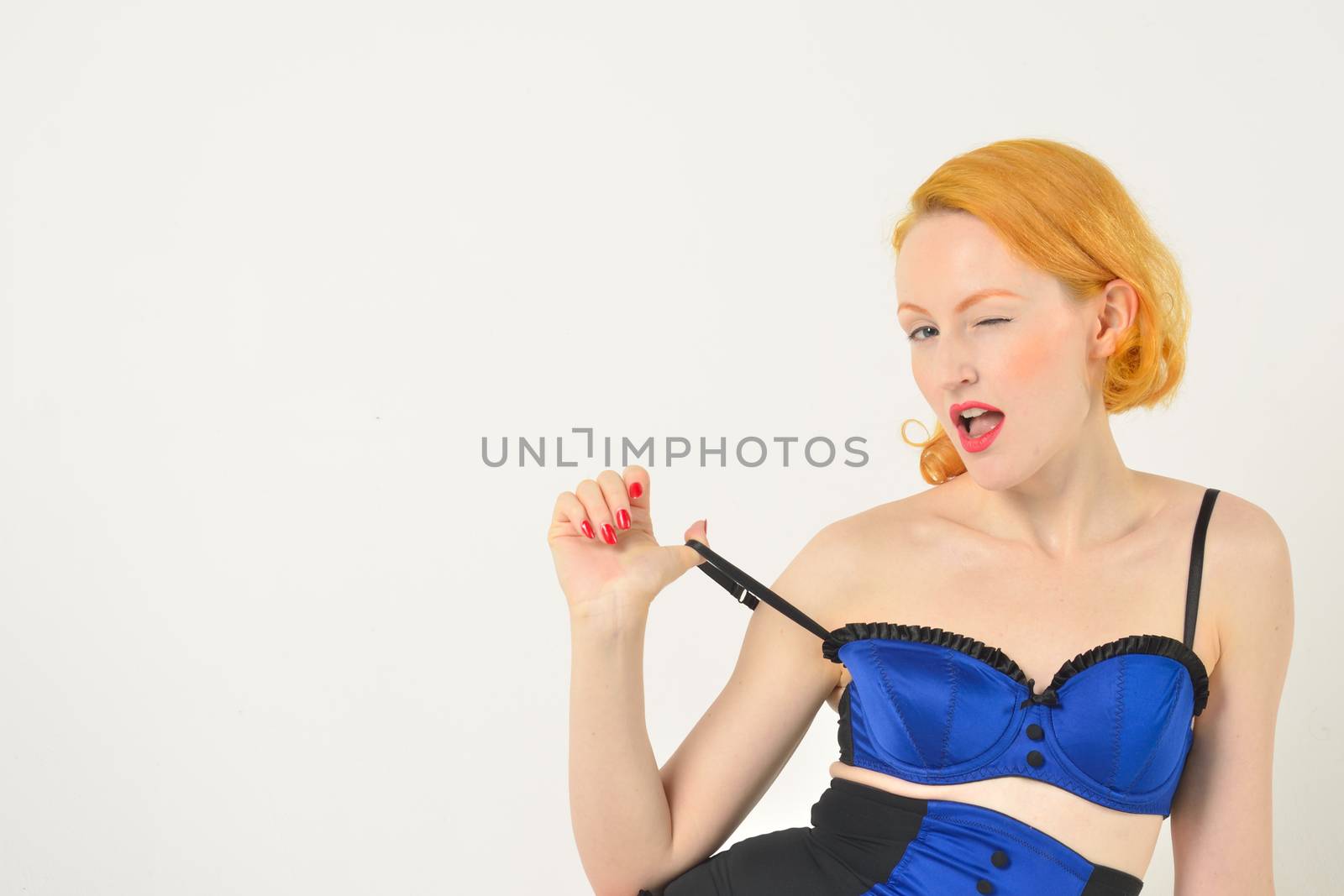 red head in blue bra winking