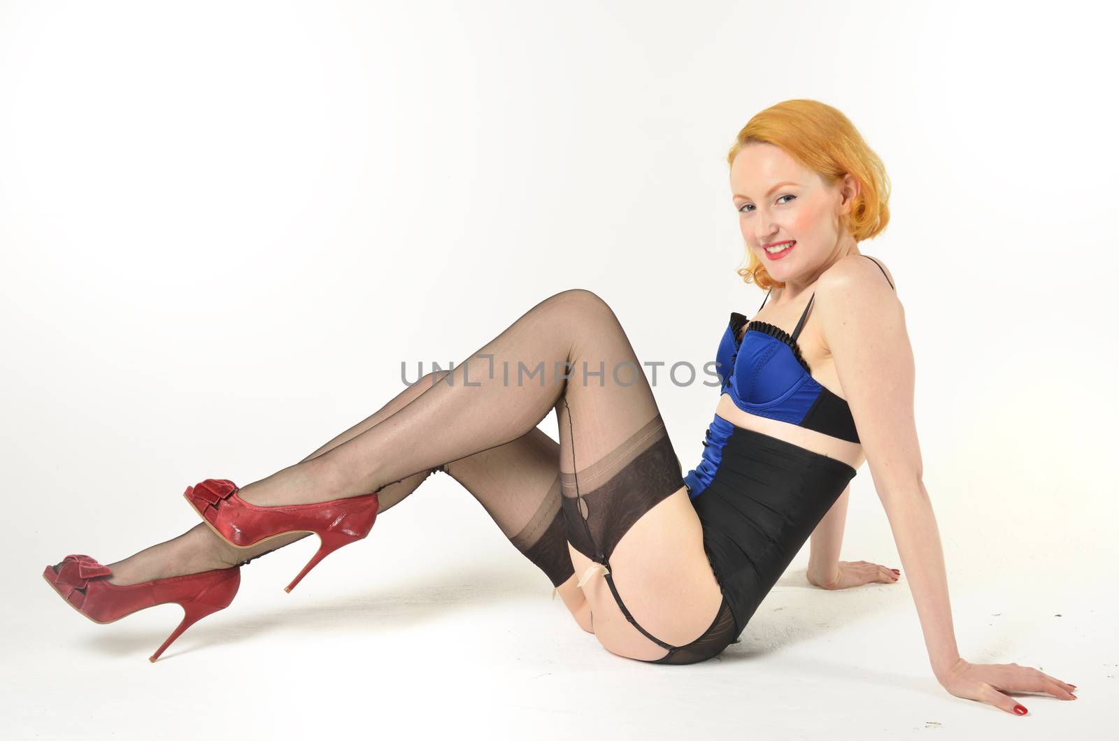 Attractive red head sitting on floor