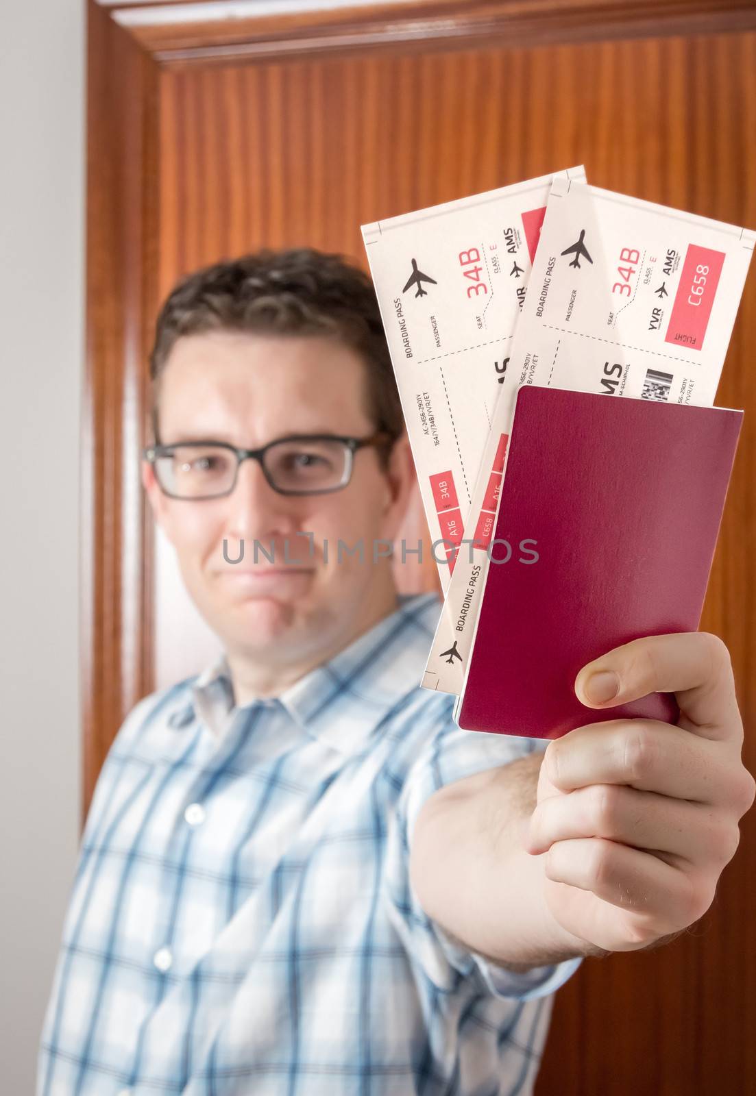 Portrait of happy man showing boarding pass and passport ready to his holidays travel