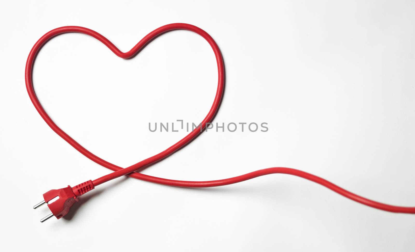 Heartshaped red cable on white background