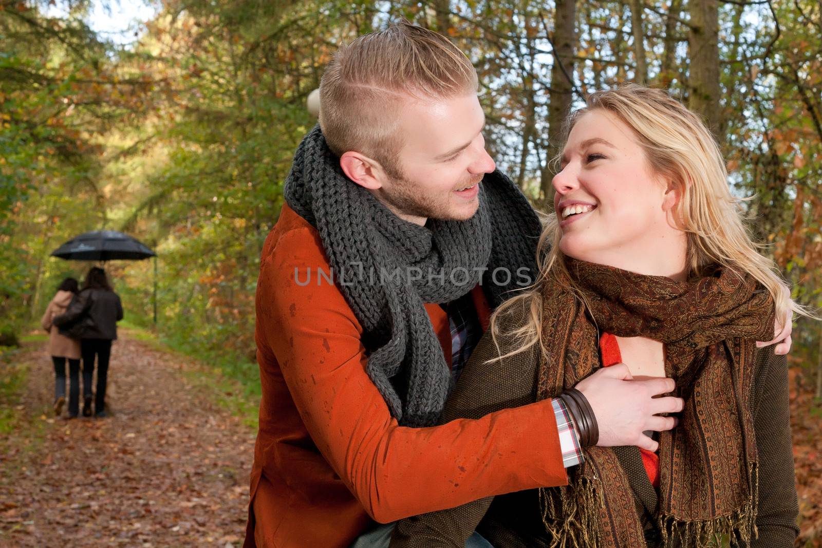 Happy young couple is having a nice time in october