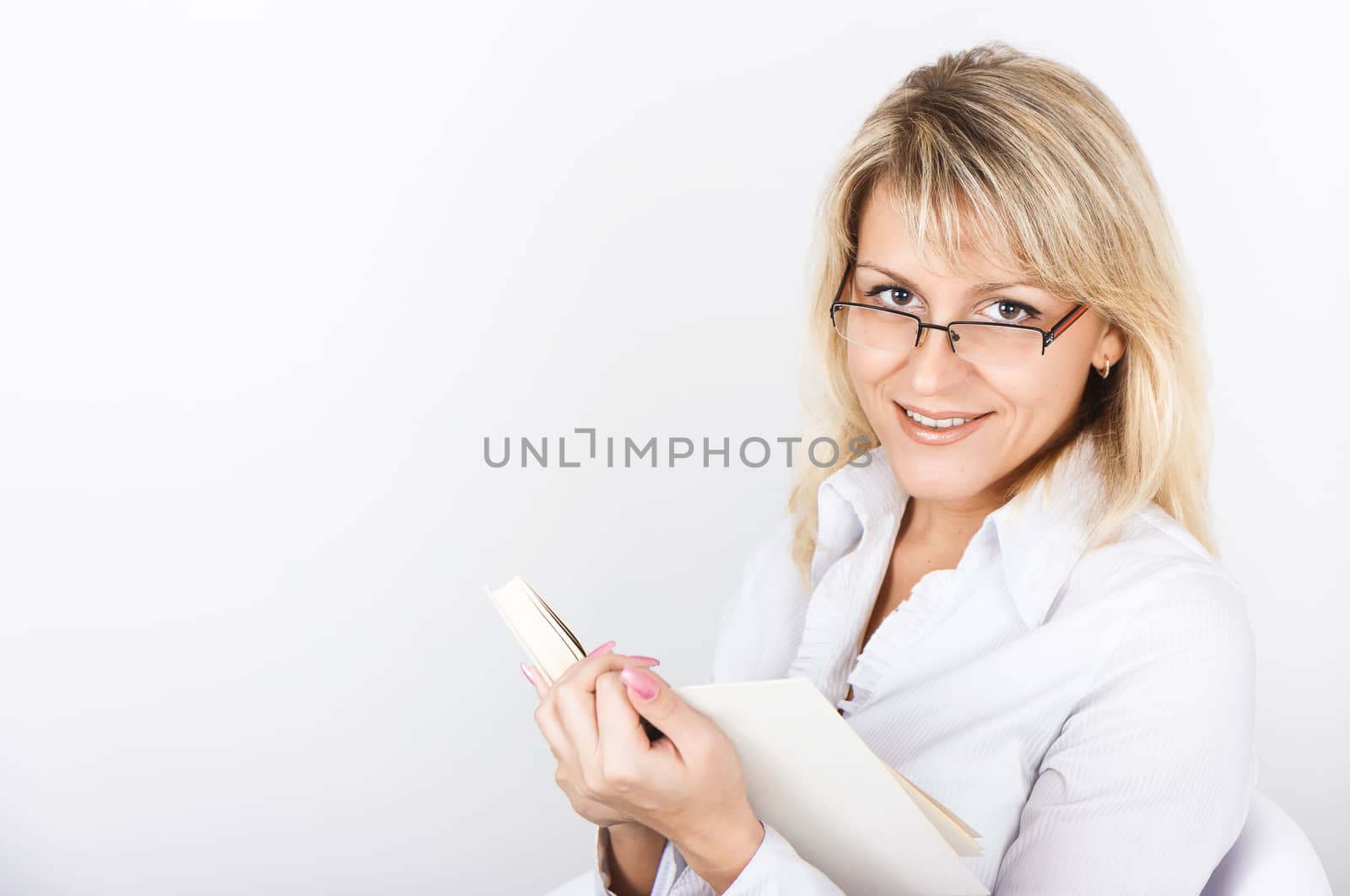 Cute blonde in glasses holding White Book