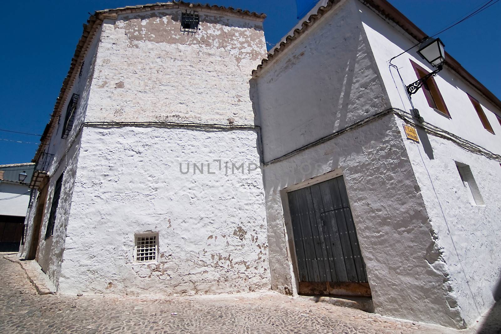 Corner of Sabiote with a wooden door and little window, Jaen, Spain