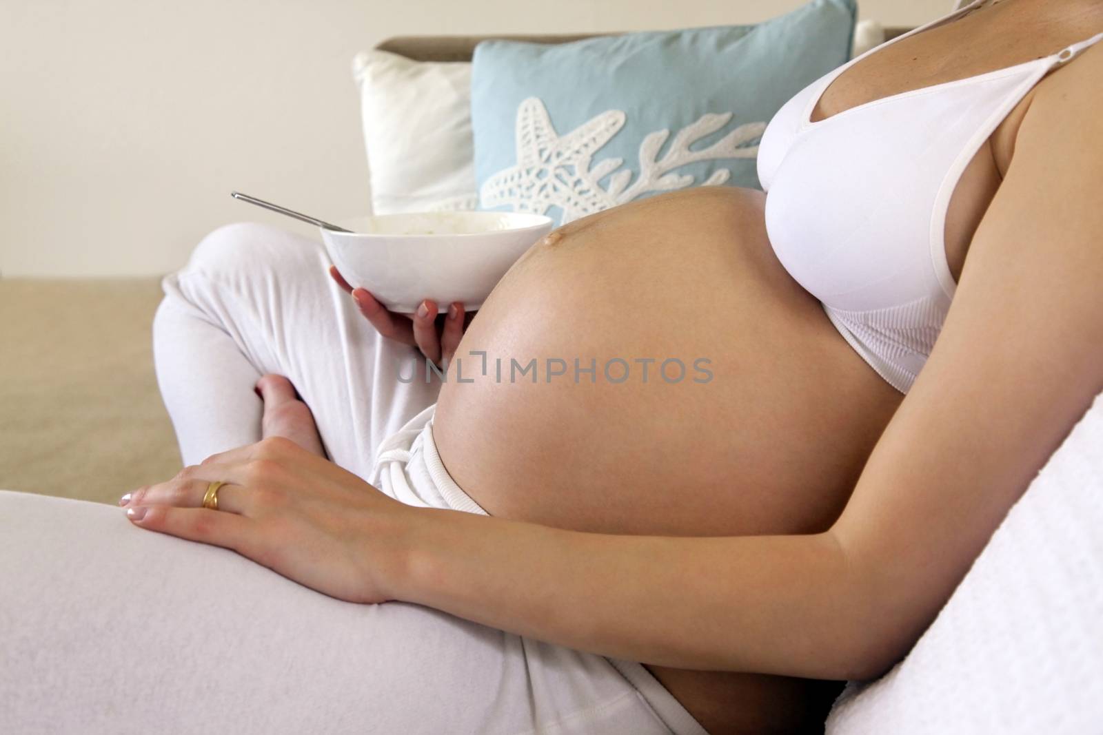 Pregnant woman sitting relax on bed