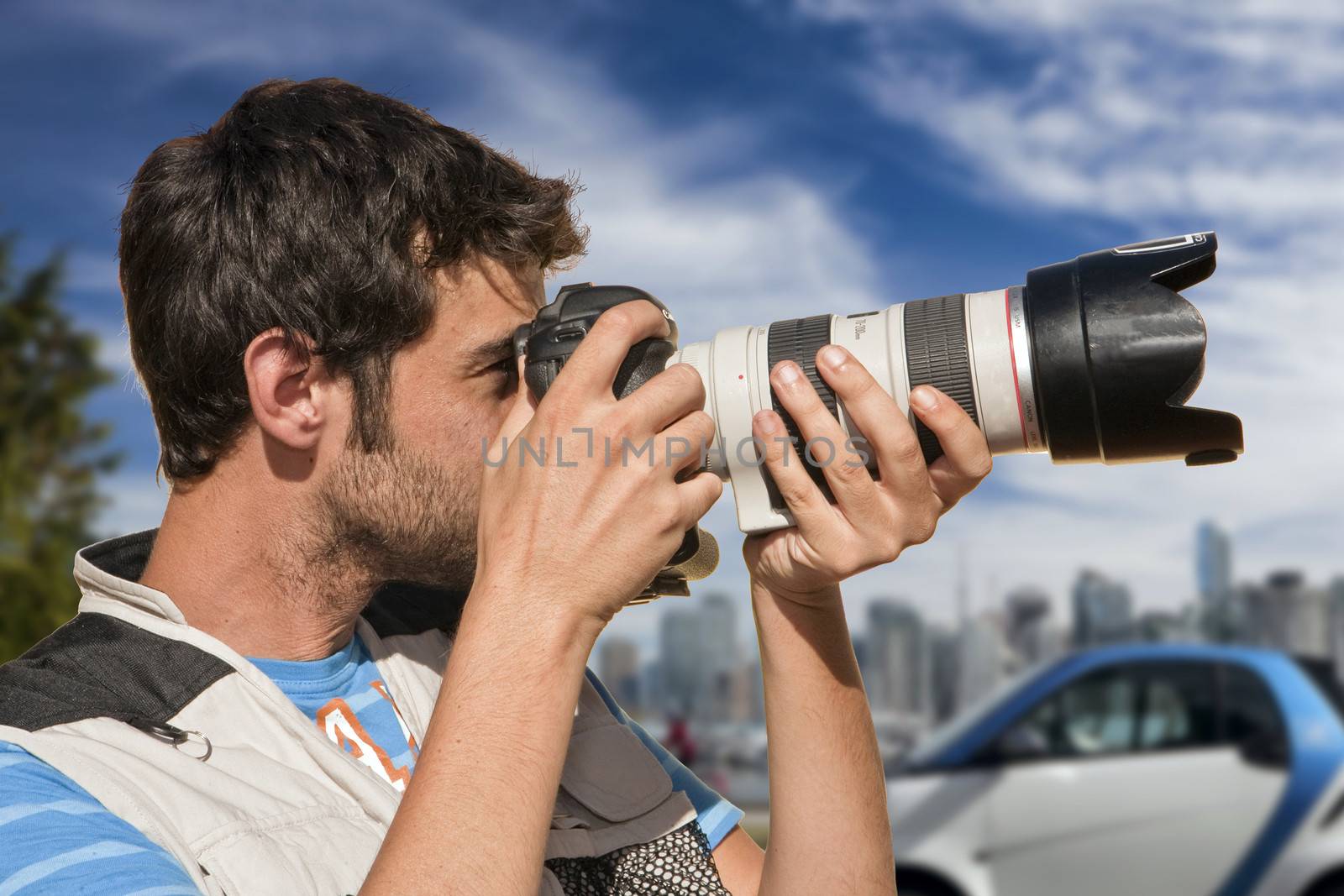 Professional photographer taking pictures with a telephoto lens, Spain