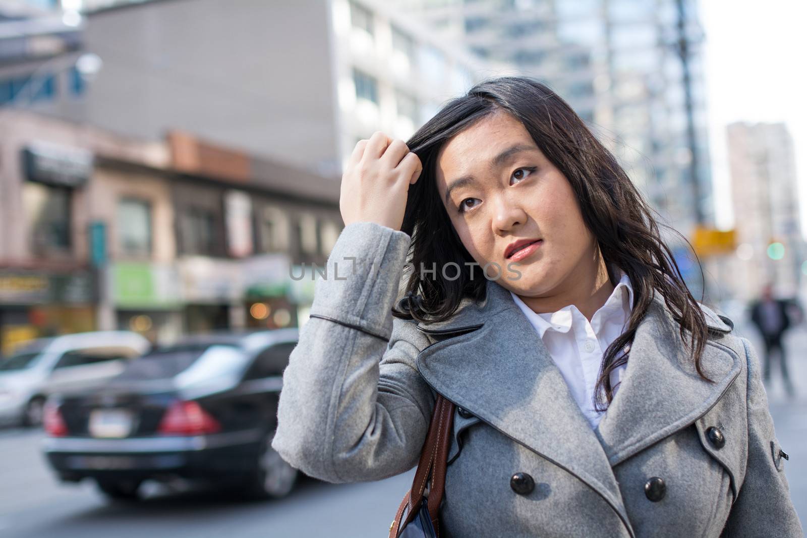 Woman on busy street by IVYPHOTOS