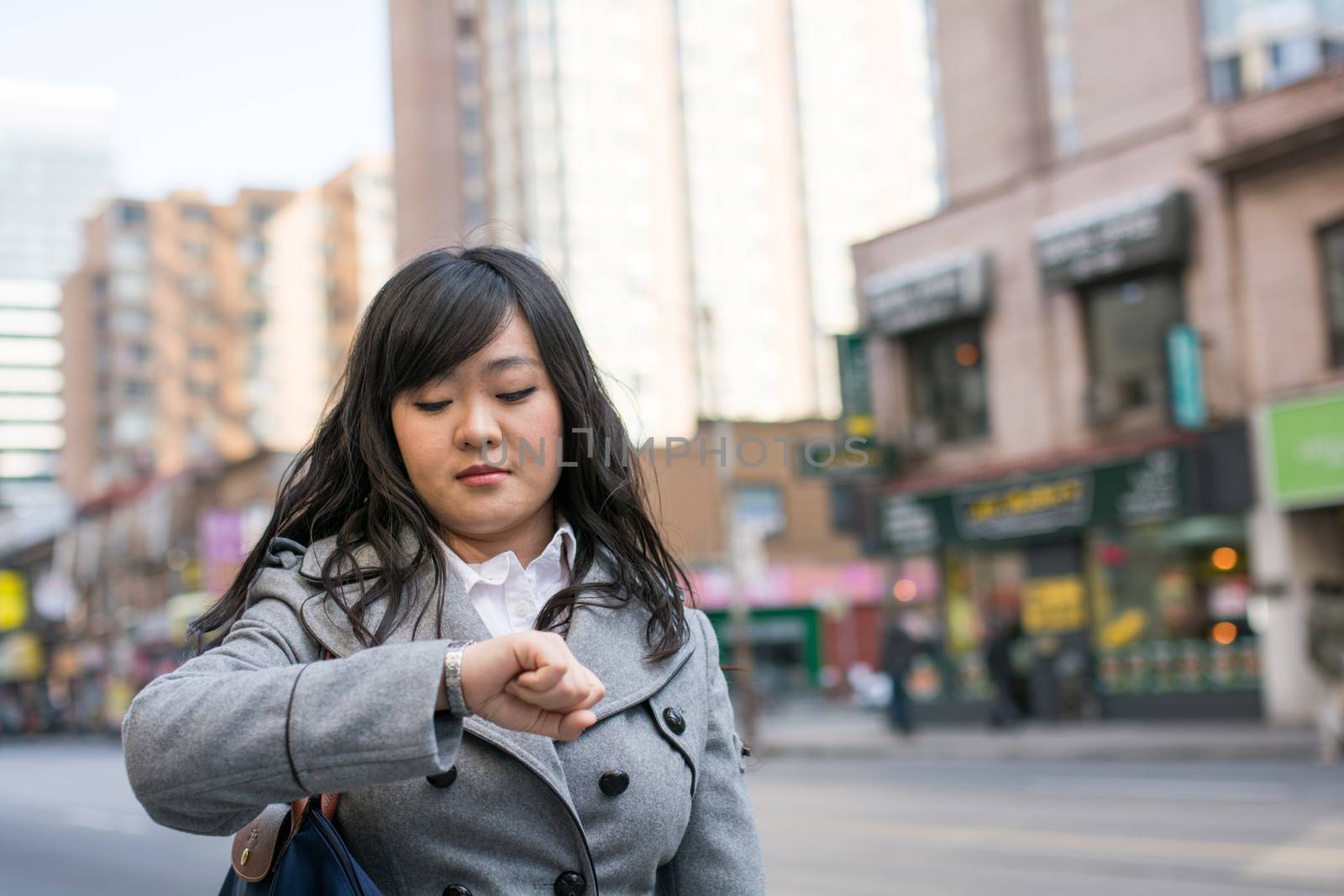 Woman on busy street by IVYPHOTOS