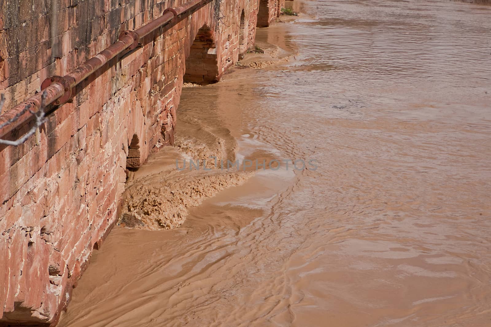 Detail of the water of the Guadalquivir River through a bridge of Roman construction, Spain