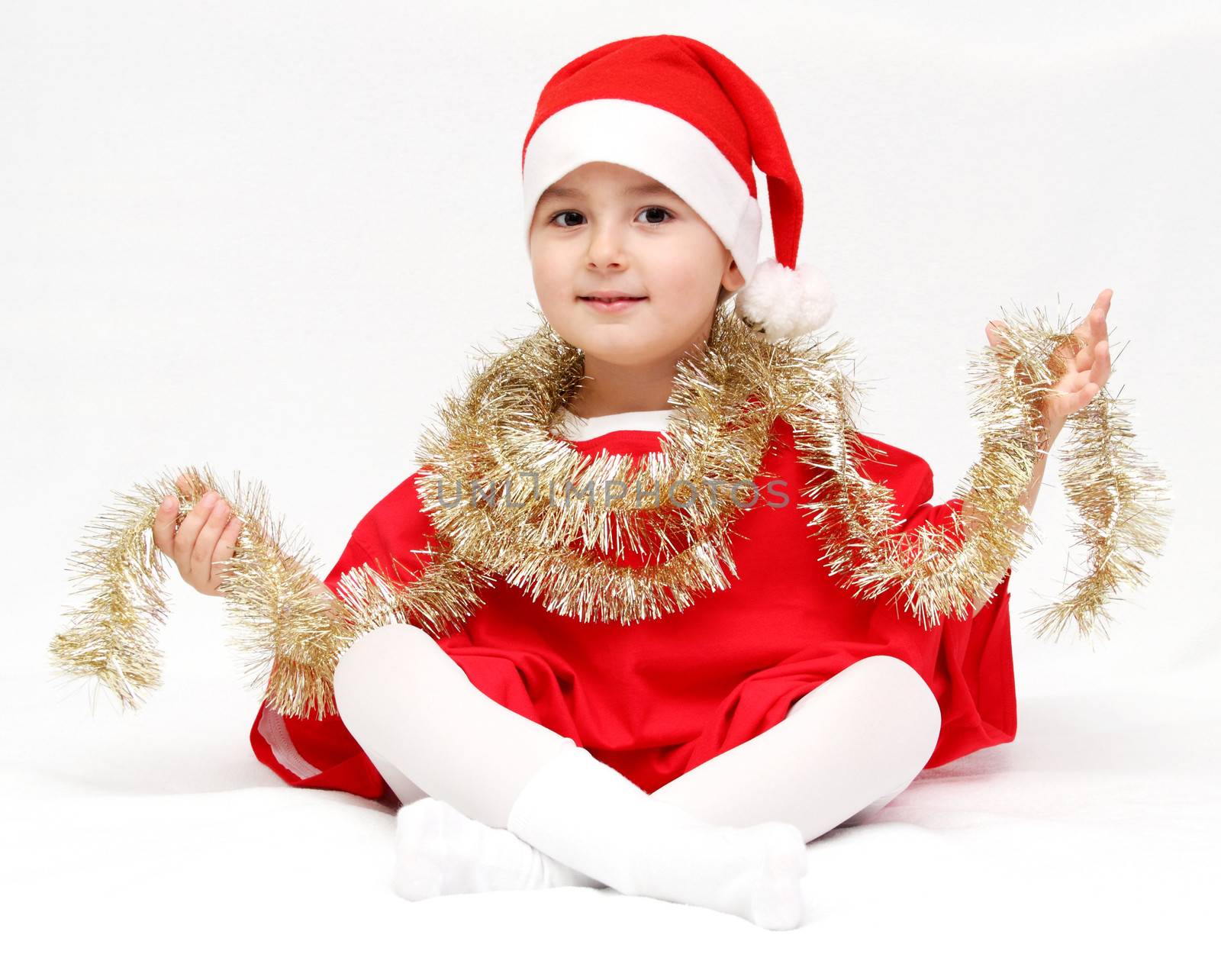 Happy child in santa claus hat by NikolayK