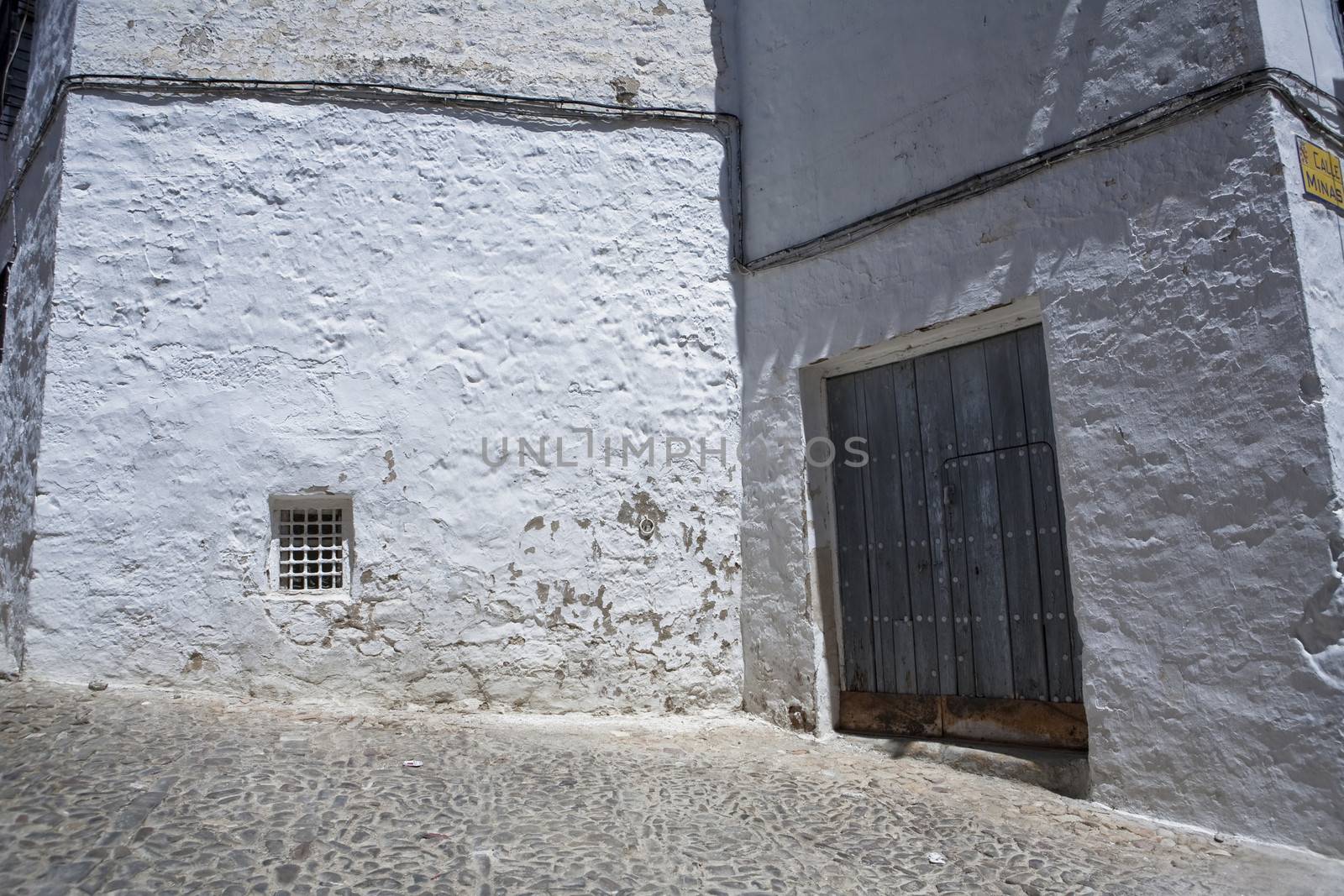 Corner of Sabiote with a wooden door and little window, Jaen province, Andalusia, Spain