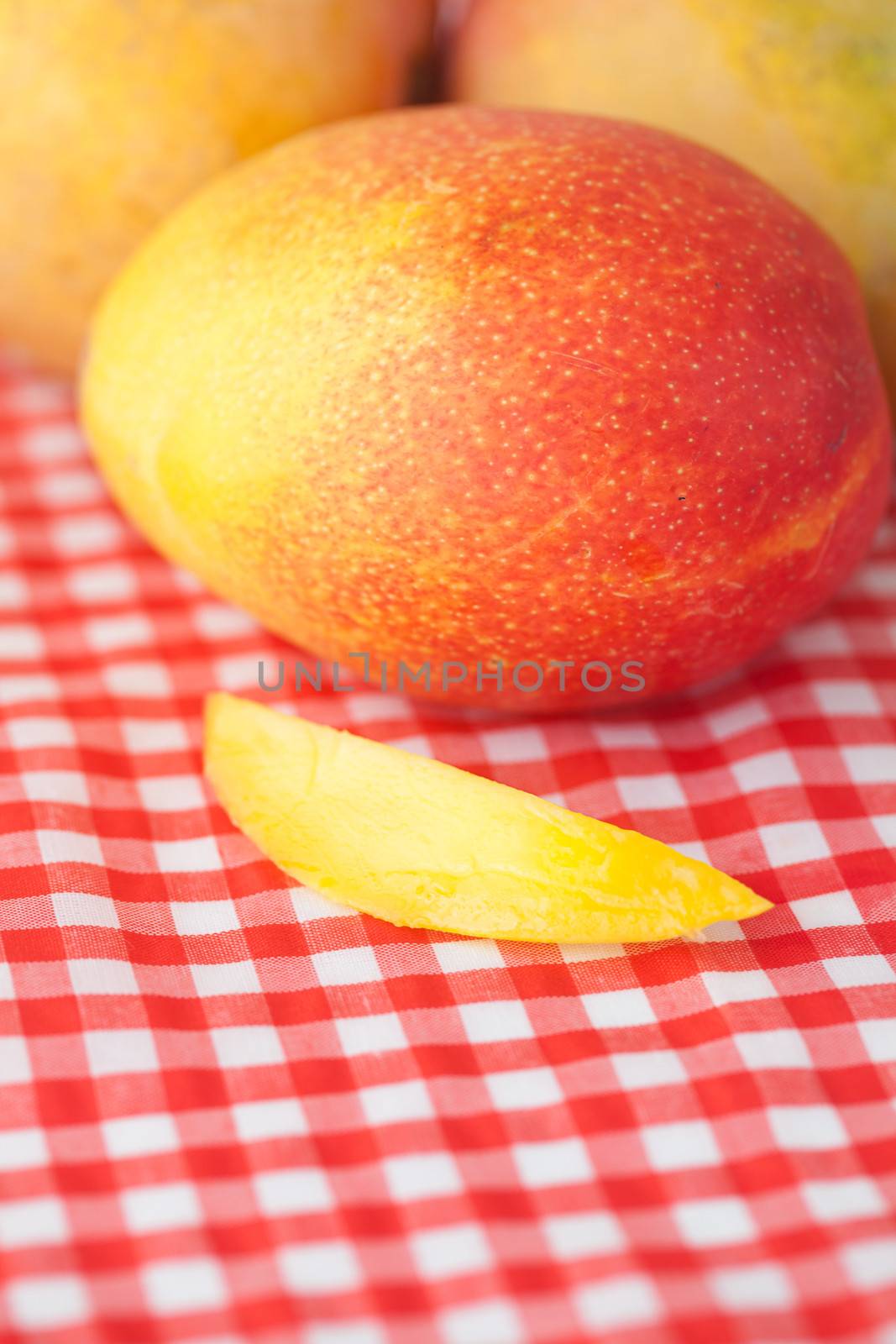 mango fruit on checkered fabric