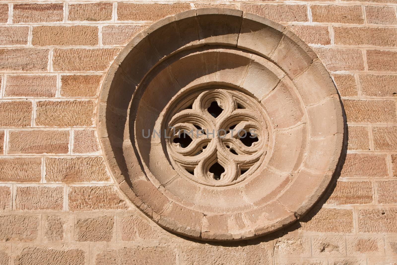 Occulus gothic. Details of the front of the side entry of the Church of Santa Maria, Linares, Jaen province, Andalusia, Spain