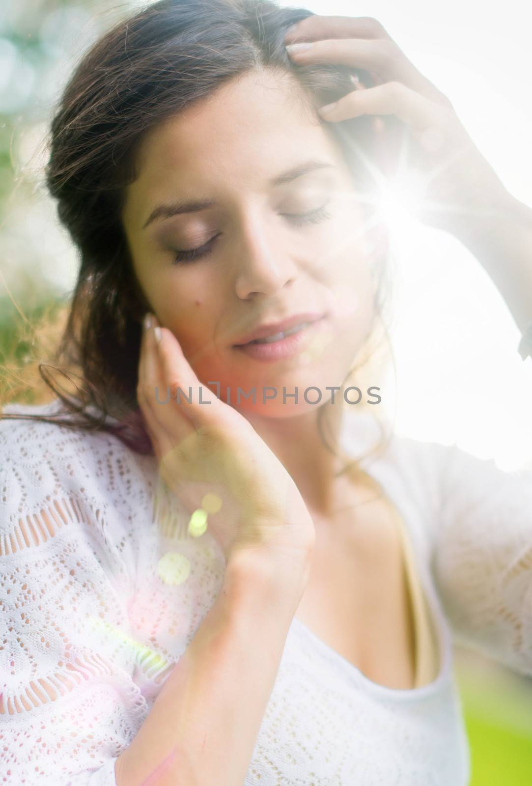 Beauty portrait of an attractive multi-ethnic girl enjoying warmth in the summer sunset. Sun Flare serie