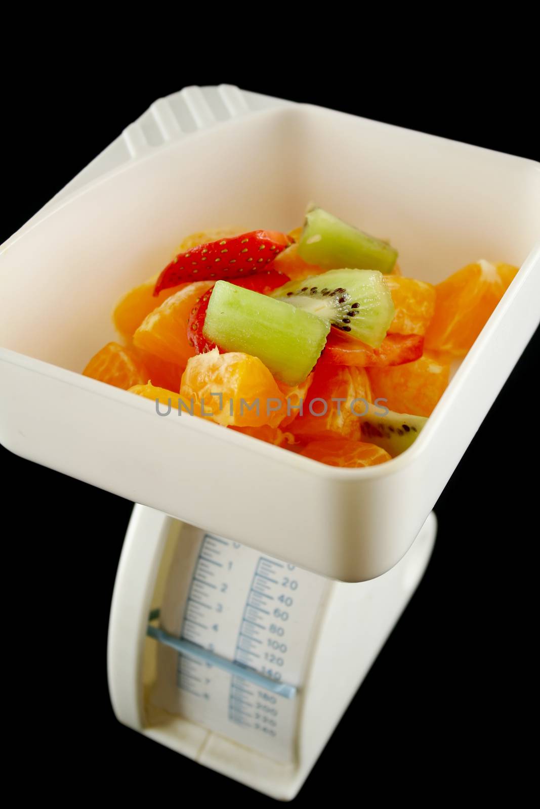 Set of kitchen scales weighing fresh fruit.