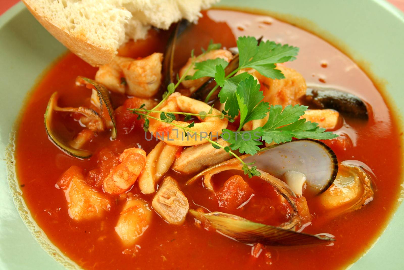 Delicious Mediterranean style tomato seafood soup with a variety of mixed seafood.