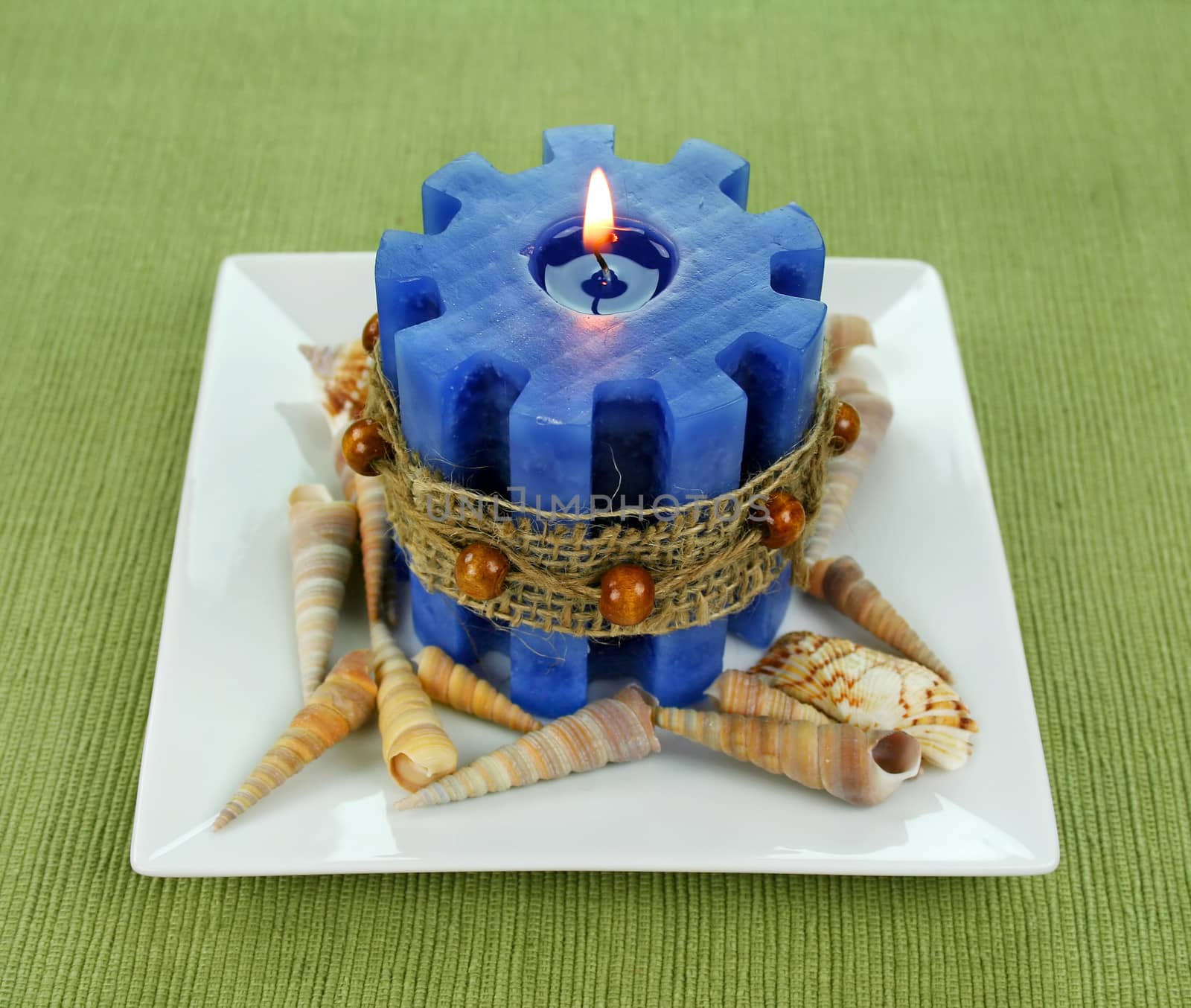 Blue marine styled candle with seashells and hessian band.