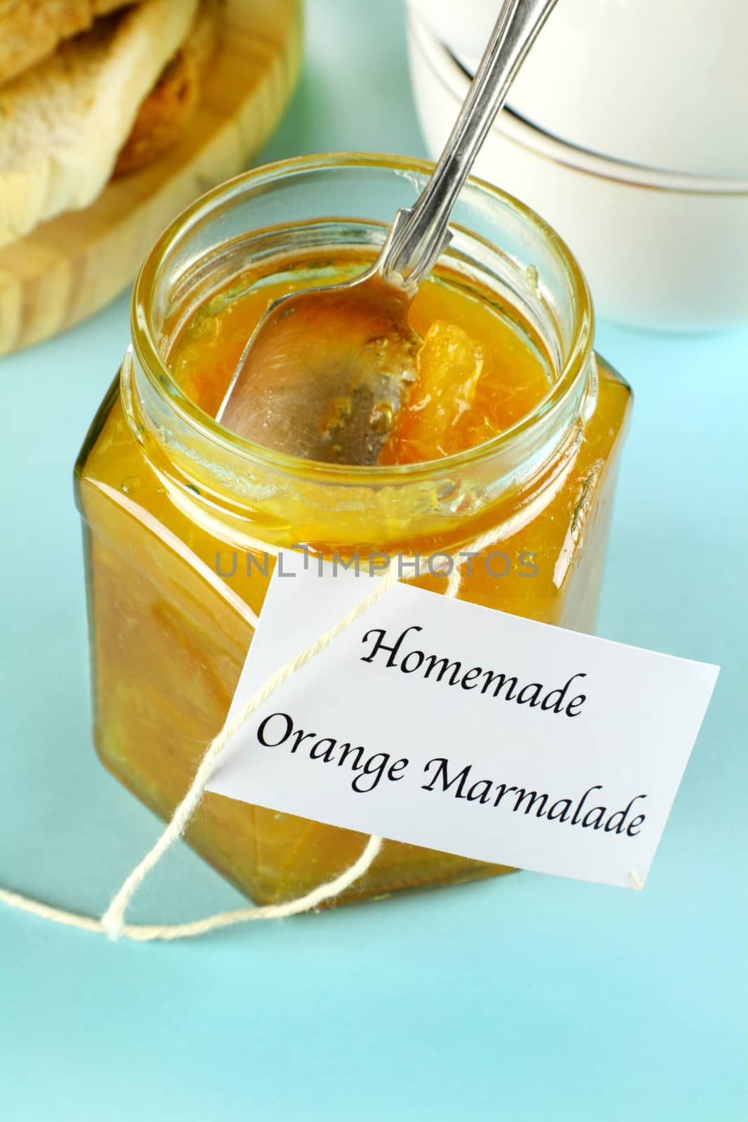 Jar of fresh homemade orange marmalade jam ready to serve.