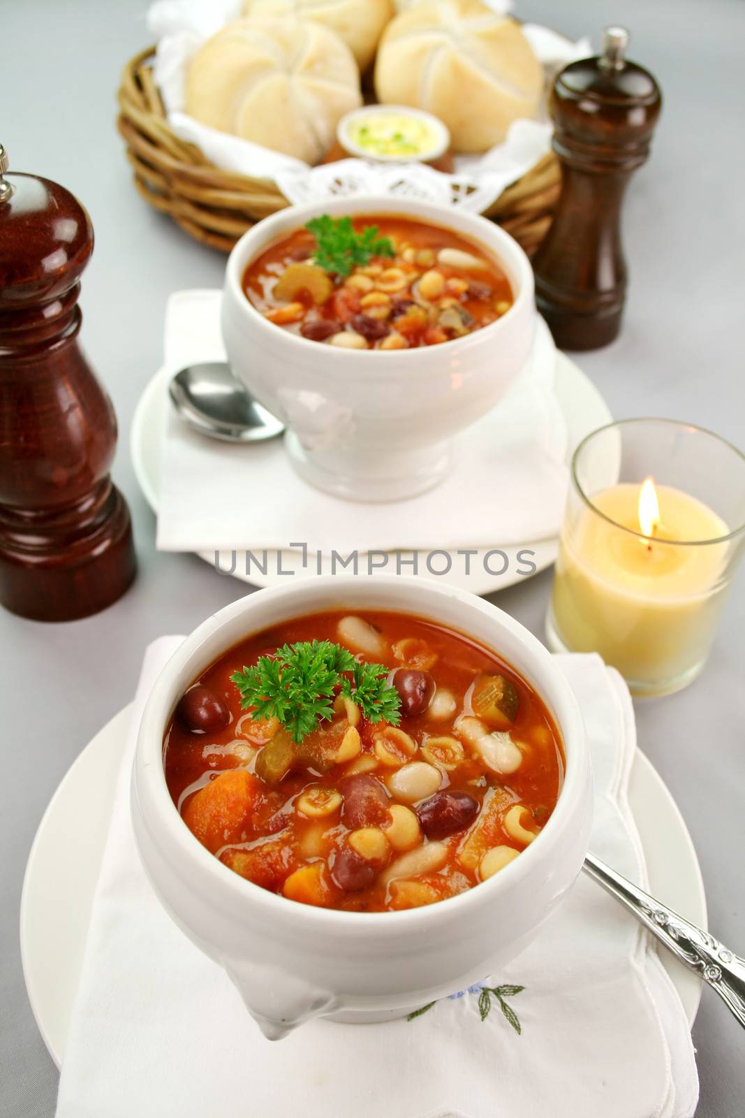 Delicious minestrone soup with fresh baked bread rolls and butter.