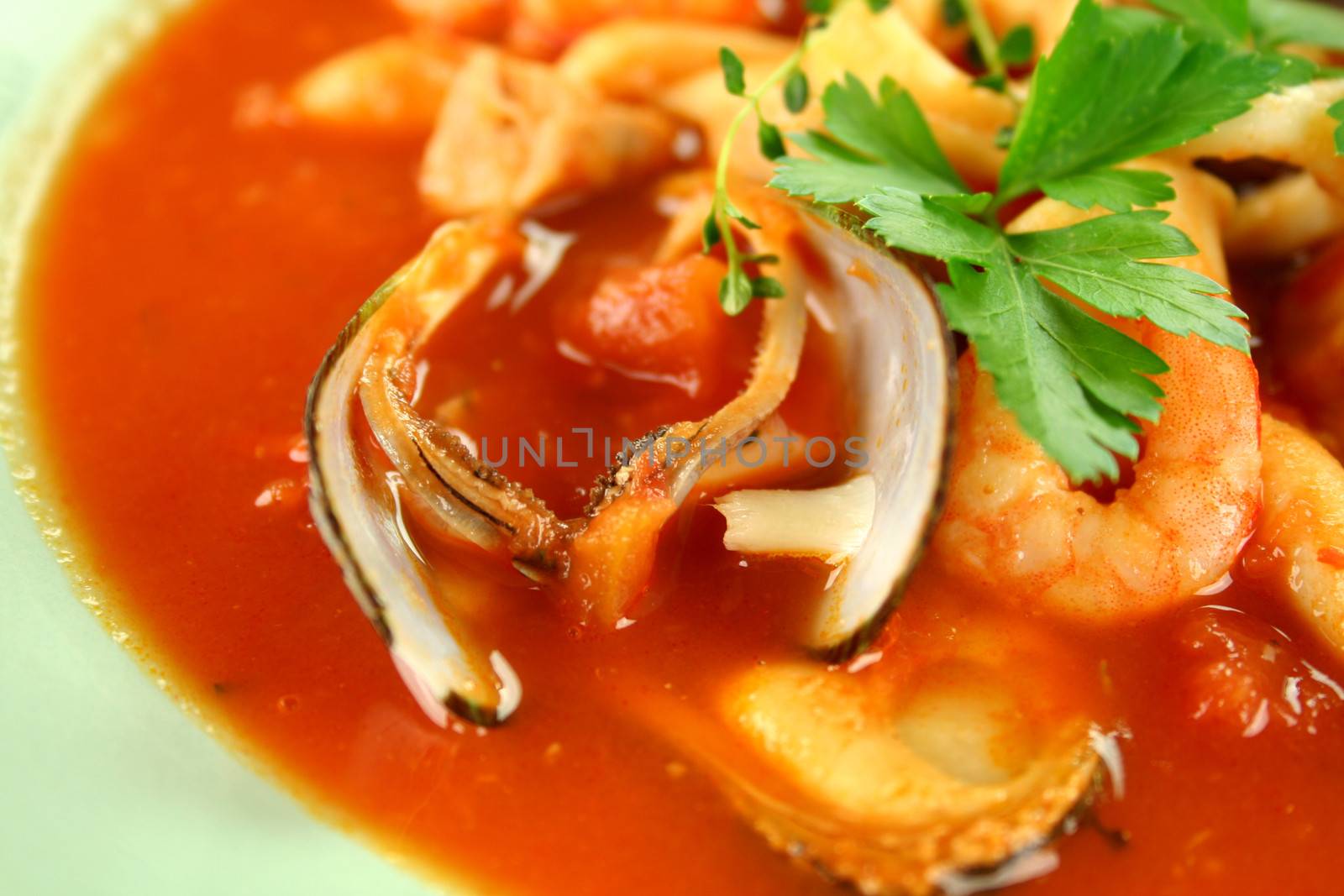 Delicious Mediterranean style tomato seafood soup with mussels and mixed seafood.