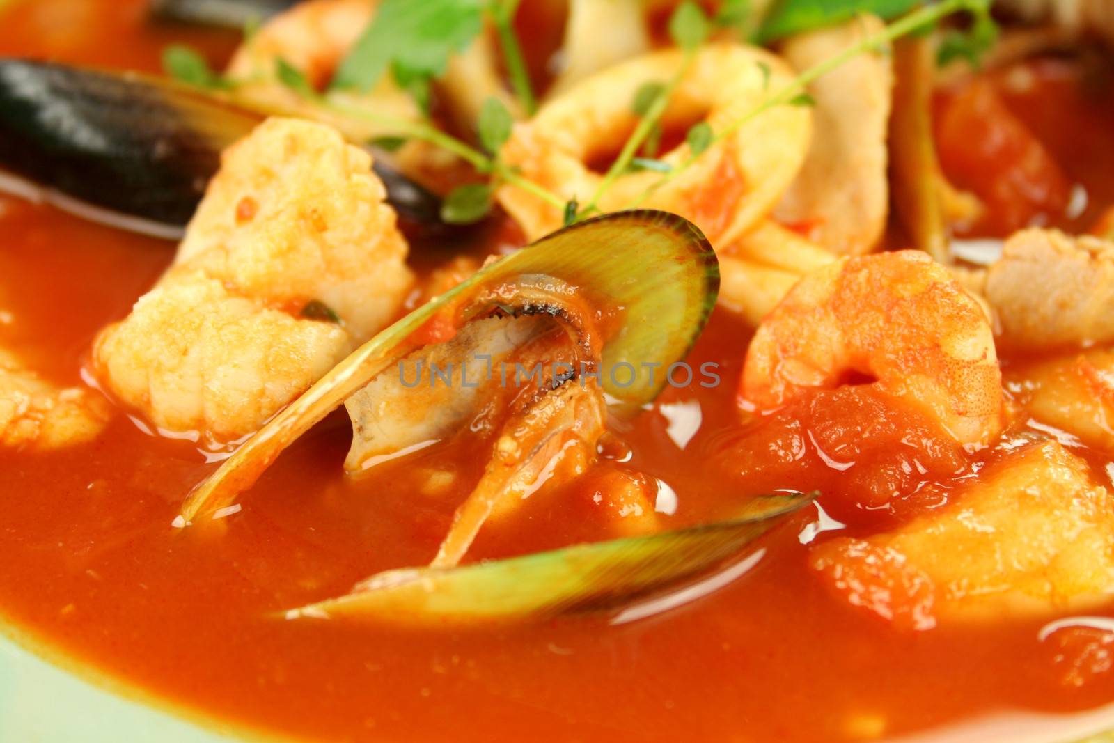 Delicious Mediterranean style tomato seafood soup with a variety of mixed seafood.
