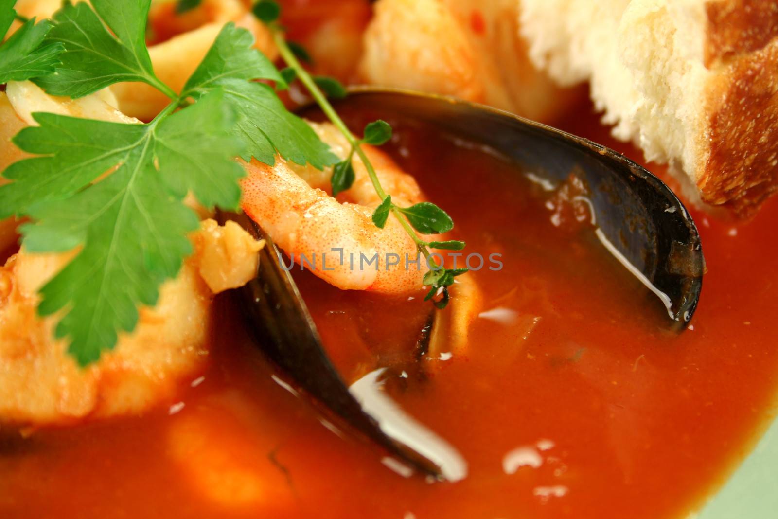 Delicious Mediterranean style tomato seafood soup with a variety of mixed seafood.