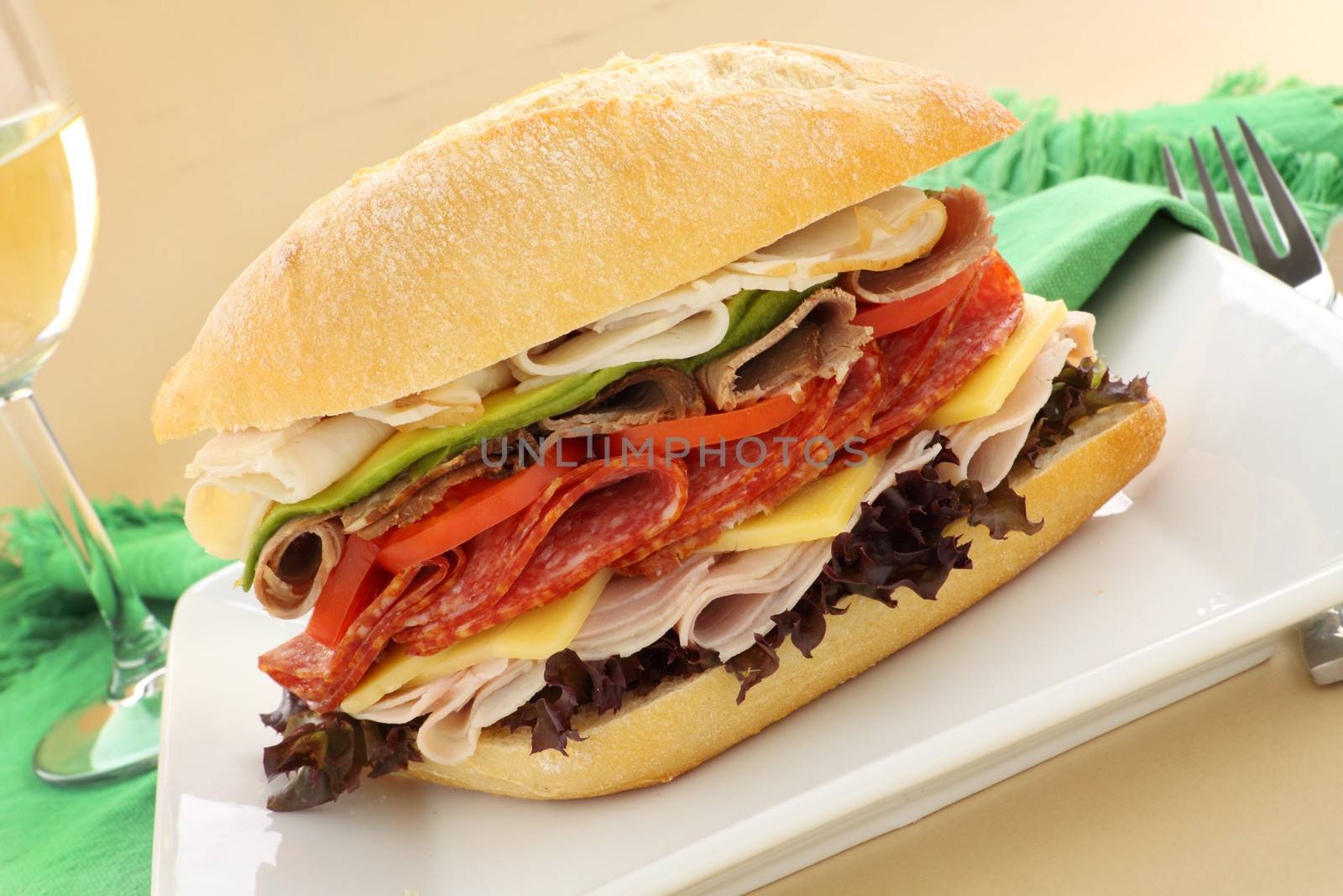 Mega meat roll consisting of ham, salami, roast beef and turkey with cheddar cheese and salad.