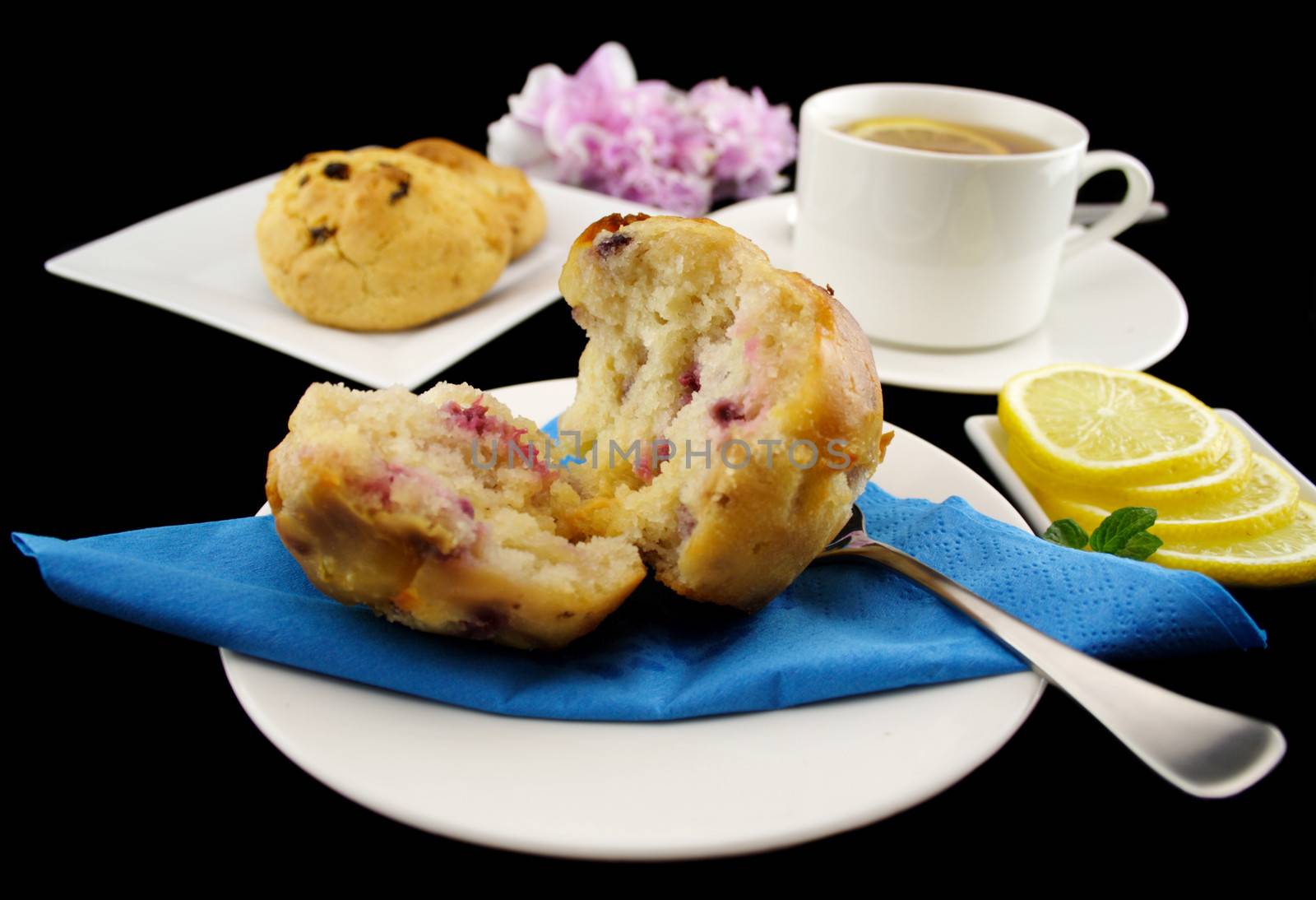 Blueberry muffin and chocolate cookies with with a cup of lemon tea.