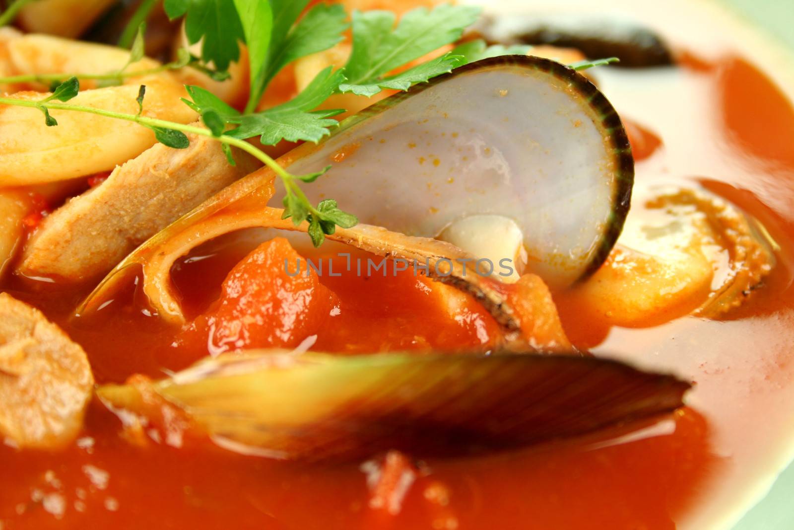 Delicious Mediterranean style tomato seafood soup with a variety of mixed seafood.